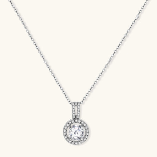 Platinum-plated sterling silver necklace with round halo pendant featuring central crystal surrounded by smaller stones